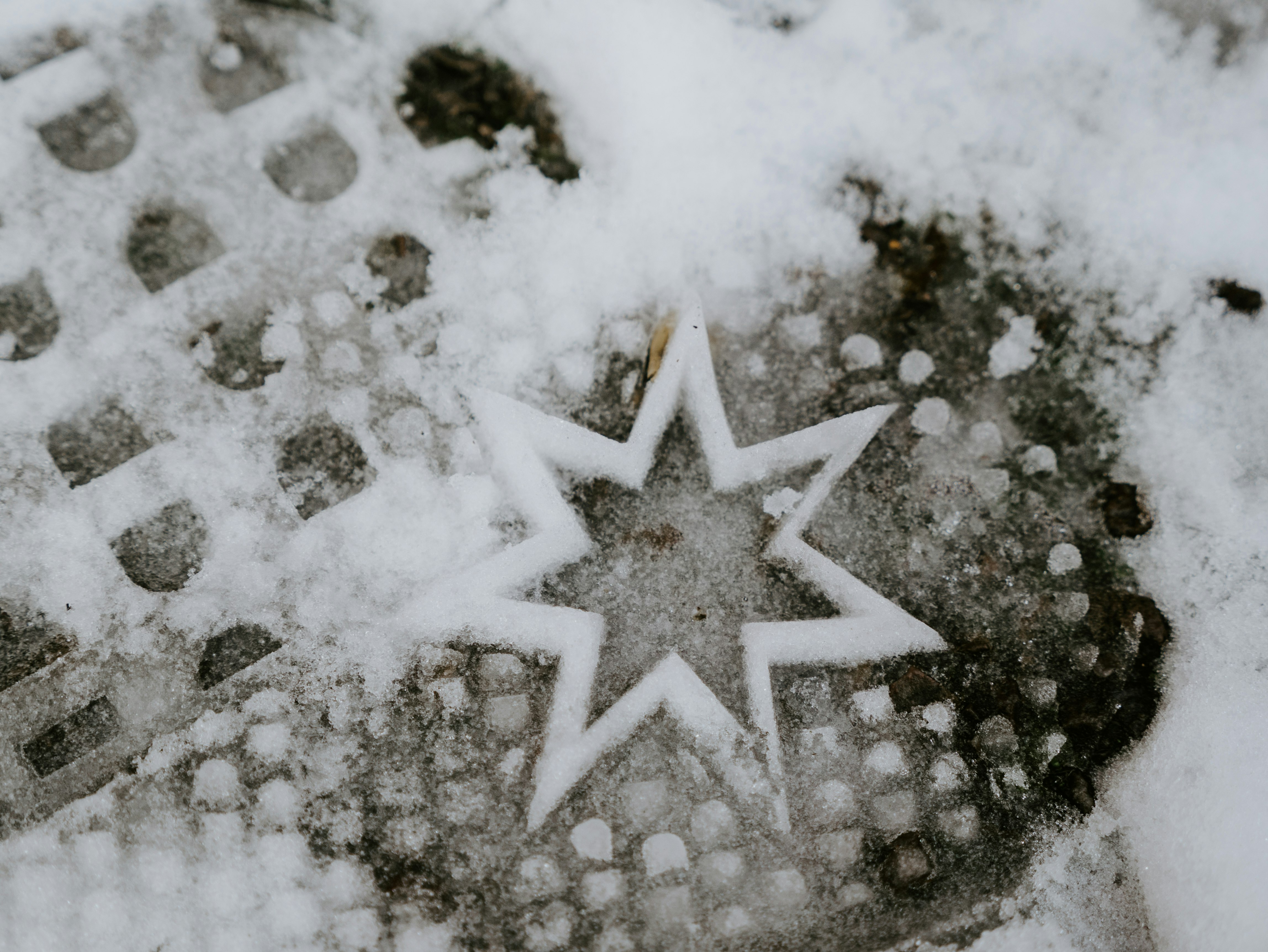 white snow flakes on gray sand